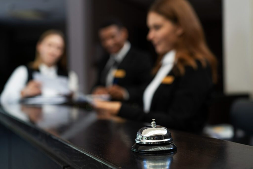 there are three staff in an hotel in black suit for hospitality